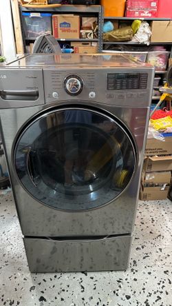 LG washer dryer set on pedestals