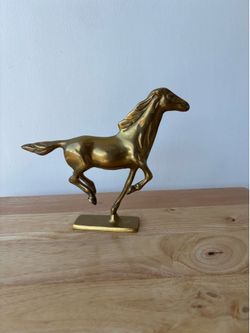 Vintage gold metal galloping horse