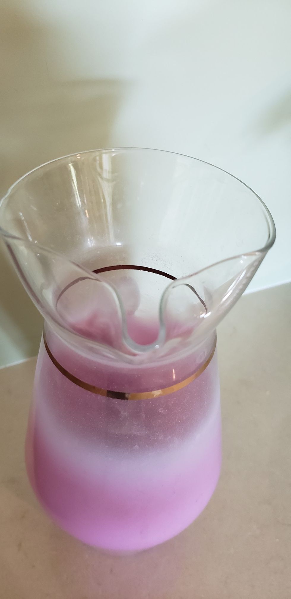 Glass Carafe with 5 matching glasses. Pink with gold trim.