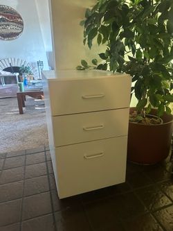 White nightstand with three tier drawers