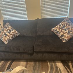 Couch And large chair with pillows Made By Broyhill And rug. 