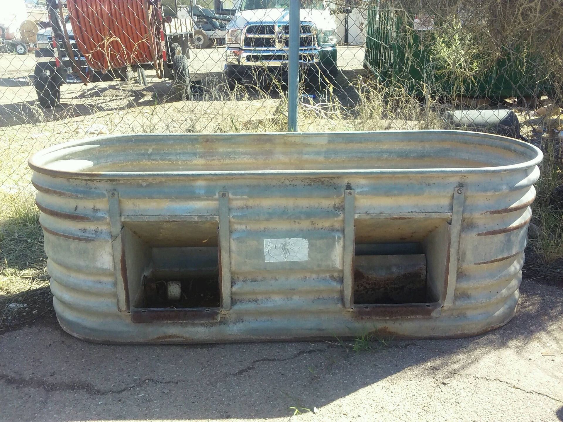 Large water trough with hog feeders