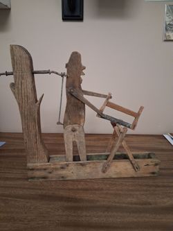 MID-20TH CENTURY, WOOD & METAL RODS and WIRES to FORM WHIRLIGIG with LUMBERJACK SAWING WOOD, on stand,  24 x 15 1/2 x 14 1/4 in...asking 180.00