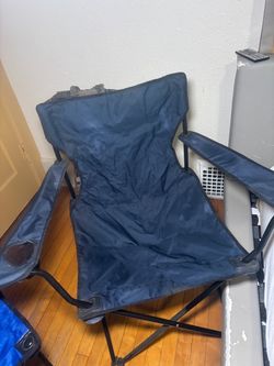 Two camping chairs and a travel bag on wheels