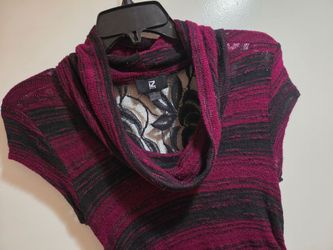 Burgundy/ red and black top. Small size. In good condition. Floral lace design on the back.