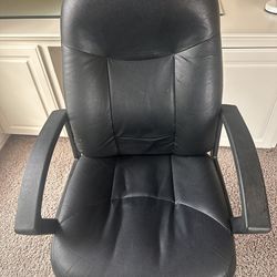 Comfortable black leather office chair with armrests in good condition
