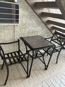 Cast iron table and two chairs