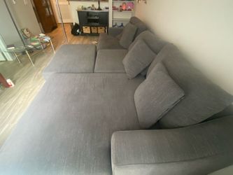 Gray fabric sectional sofa with chaise and matching ottoman