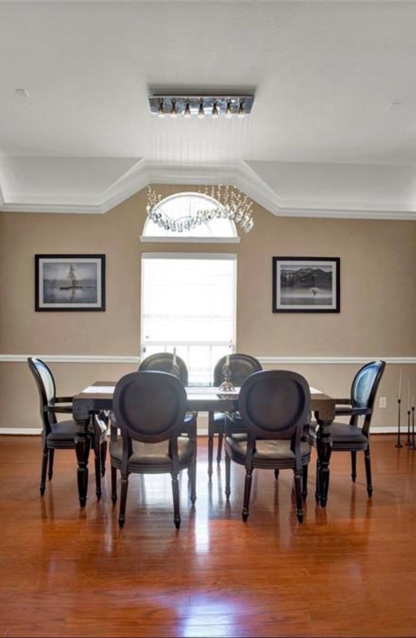 Modern baroque black lacquer dining-room table with crocodile pattern chairs