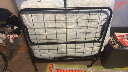 Twin size fold up bed with mattress on wheels