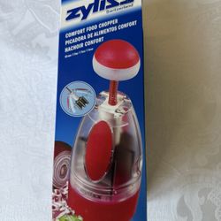 Top brand Zyliss Comfort Food Chopper from Switzerland. Dishwasher safe. New. Still in box. Features a unique comfort top, automatically rotating stai