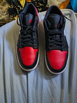 Black and red low top Jordans shoes size 10