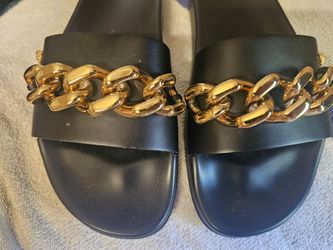Versace black leather slides with the gold-tone chunky chain and Medusa detail.