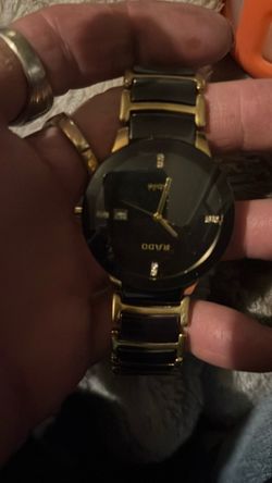 Rada black and gold tone watch