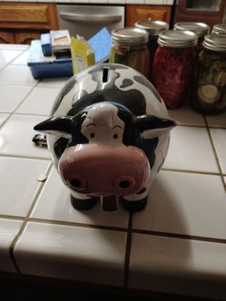 Cow colored piggy bank