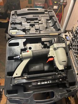 a Porter-Cable BN125A 18-gauge pneumatic brad nailer with case