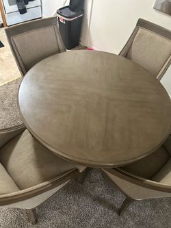 Round wood table with 4 upholstered chairs