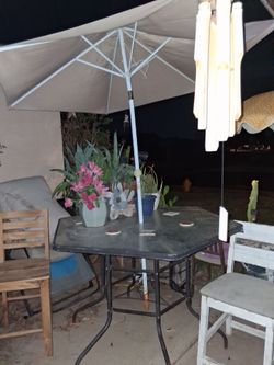 Glass bar height table bar stools and umbrella