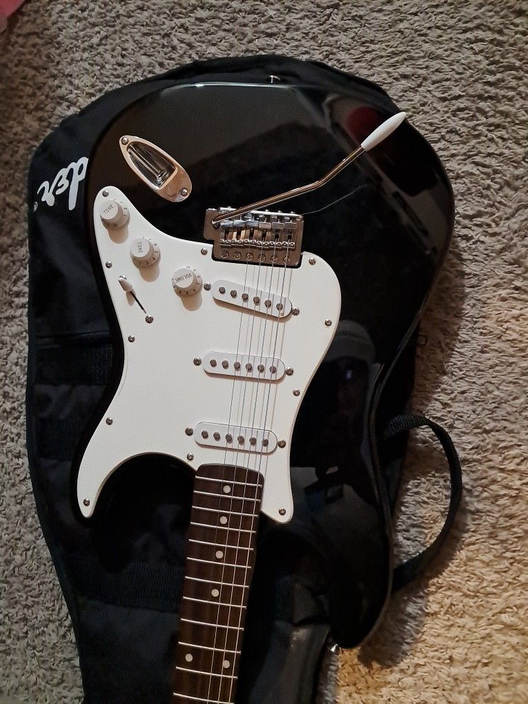 Squier Strat Electric Guitar With Squier Champ 15 Amp And Tuner Etc