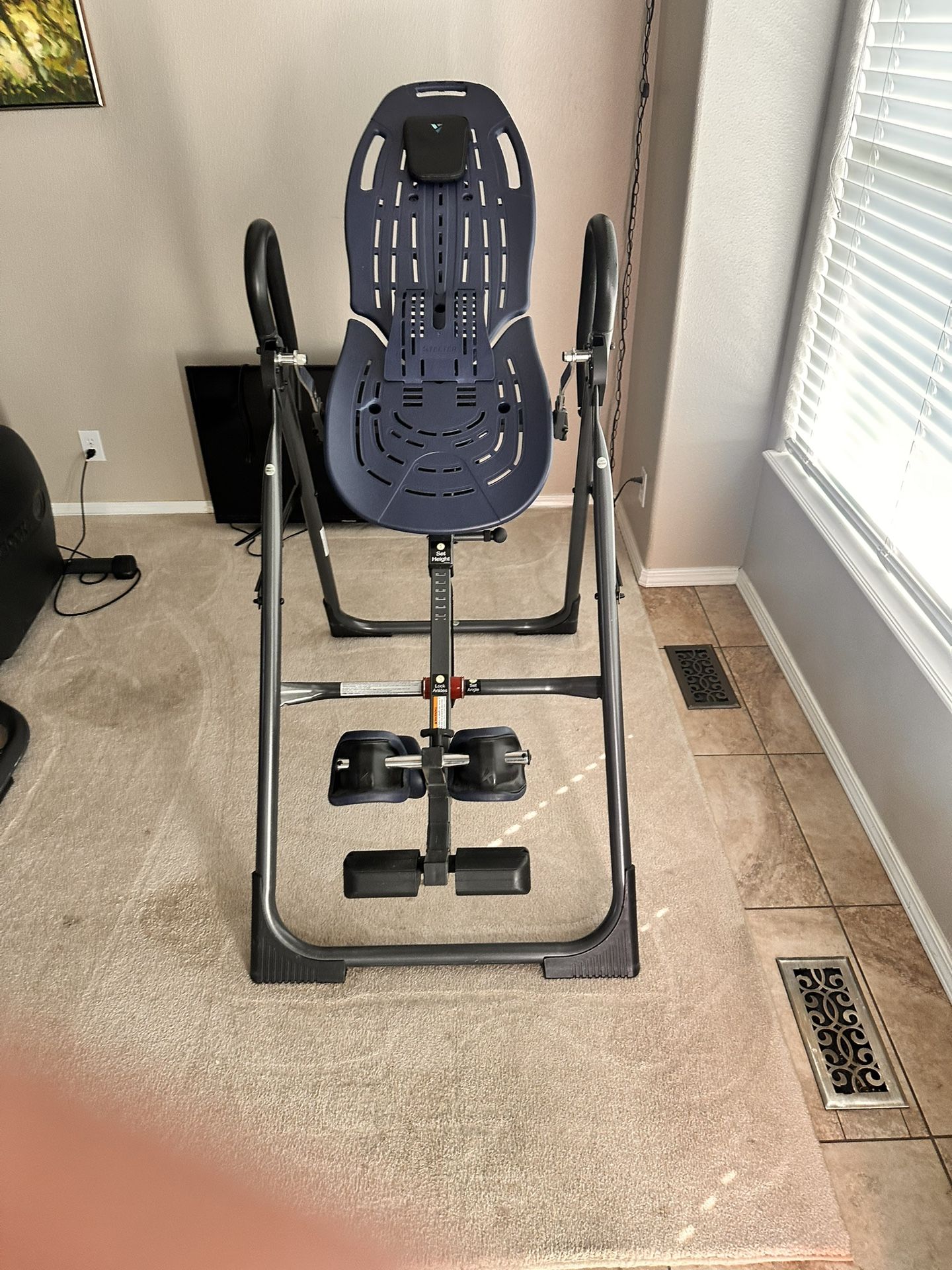 Teeter Inversion Table, specifically a model from their FitSpine or EP-series, designed to provide natural back pain relief and improve spinal health 