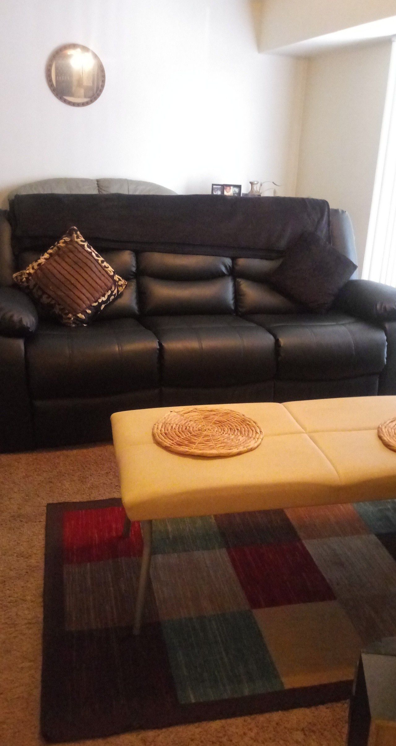 All black leather recliner sofa and loveseat..Movie theater style with cup holders