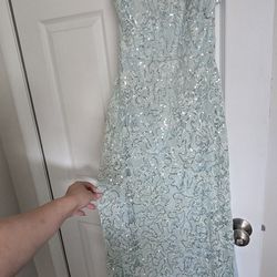 This is a light blue, sequined lace evening gown.