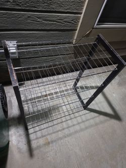 Shoes rack with 4 metal wire shelves. Functional.