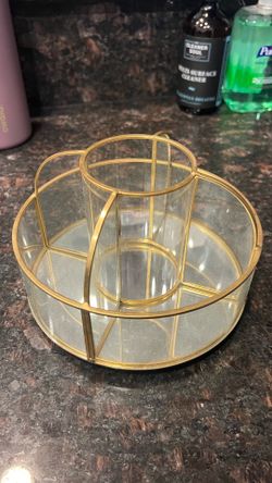 Rotating glass and gold makeup holder