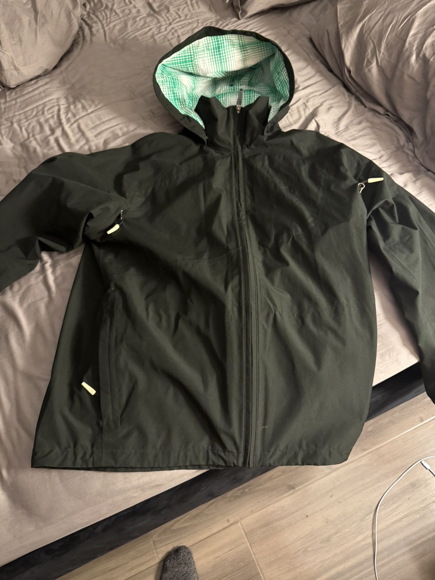 SPYDER - Mens Snow/Ski/Rain/ Wind Shell Jacket. Mens size: M. Black w/ Green Plaid Lining. With Removable/Adjustable Hood and pit-zip vents.