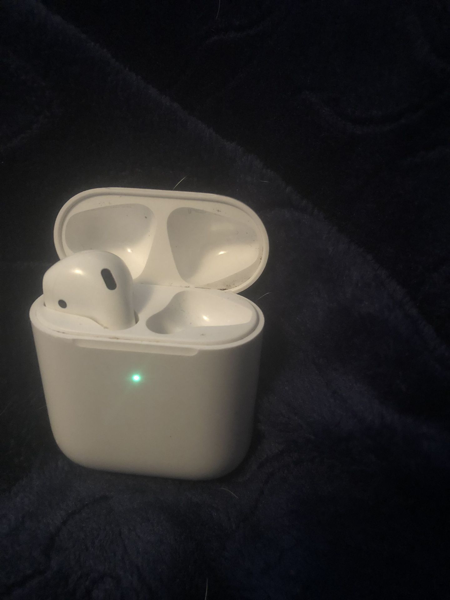 Left AirPod with charging case