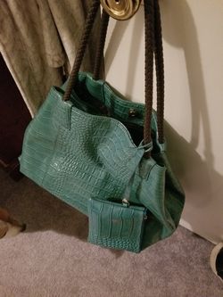 Turquoise Buddha bag. Comes with small makeup bag attached. Large enough for overnight trips.