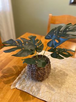 Faux Monstera plant in Seagrass pot. 12 inch tall. Good condition . Bo Ho / farmhouse/ cottage.