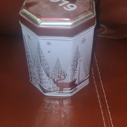 Stockmeyer musical Christmas tin from 2019. 
The tin is a hexagonal music box that plays a classic holiday tune when opened. 
It typically contains su