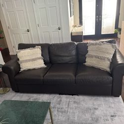 Dark Brown Couch With Two Pillows 