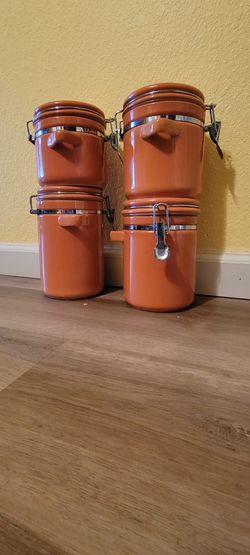 Four-piece orange canisters 
