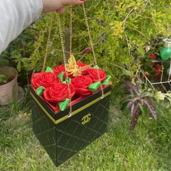 red eternal roses in Chanel bag