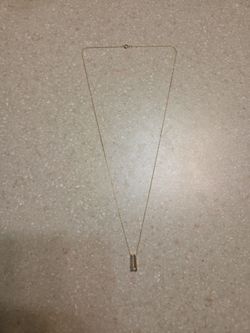 10 k gold necklace with 10 k gold diamond pendant.  Weight is 1.4 grams