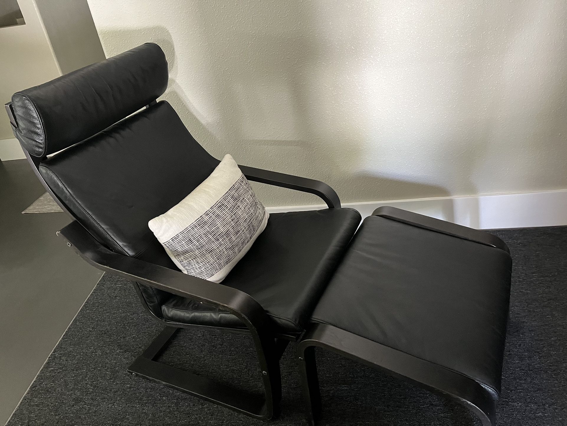 Pair of Ikea Poang black leather lounge chairs and ottomans