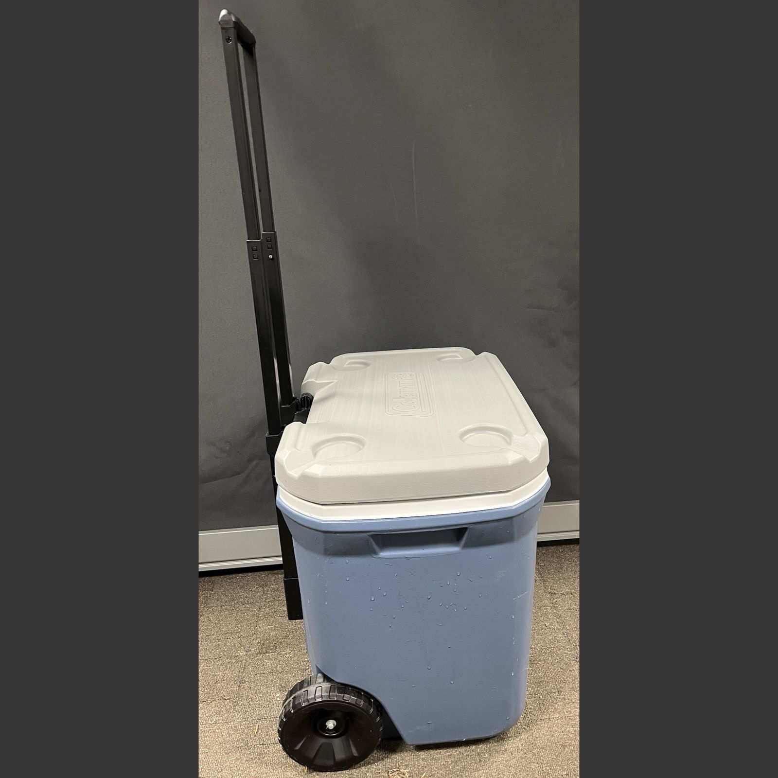 Coleman 60 Quart Cooler on wheels with pull handle, 4 drink holders.