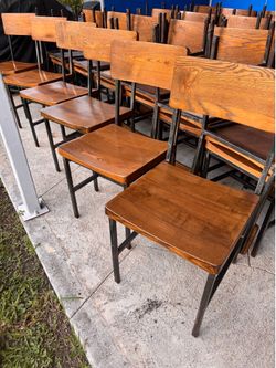 48 beautiful  chairs.  Industrial style steel frame with solid reclaimed wood seats and backs in Natural wood tone.  Very good condition..$40ea.