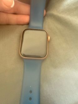 Apple Watch Series 6 (44mm) GPS + Cellular in Rose Gold Aluminum with a blue sport band.