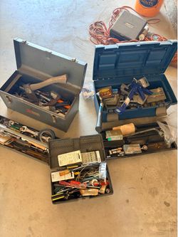 3 tool boxes filled with random tools, screws, and two staple guns.