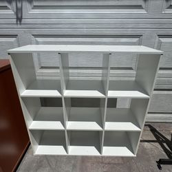 Like new white wood 9 layer shelf cube bookcase. Measurements: 12deep x 38”6W x 36H. 