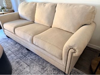 Cream upholdered nailhead sofa couch