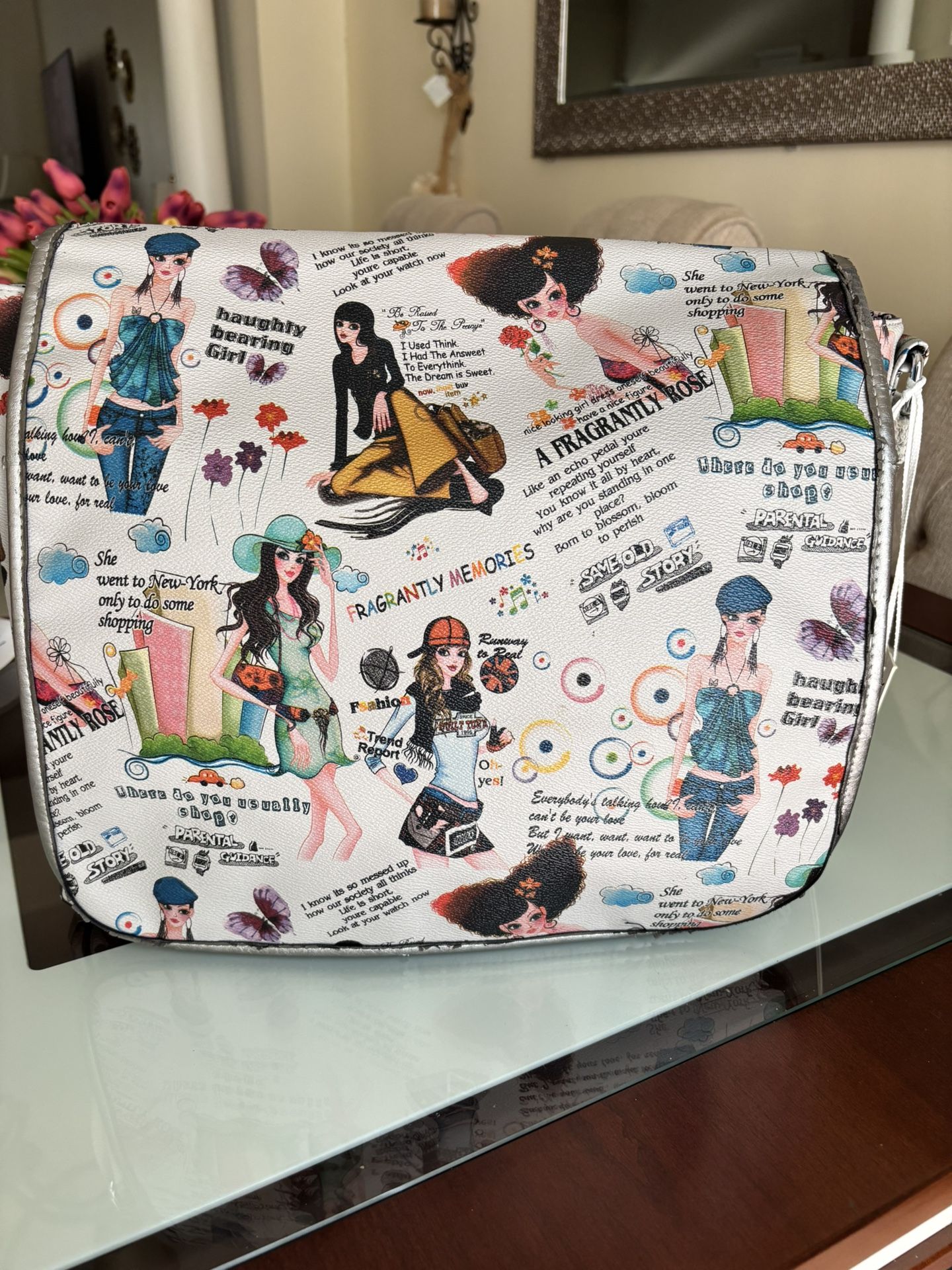 Vintage Elevate your style with this trendy crossbody bag featuring a vibrant graphic design. Perfect for adding flair to any outfit. In very good con