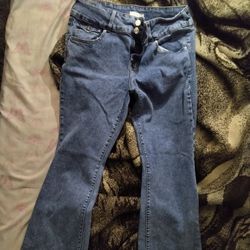 Pacsun blue denim jeans feature a flared or bootcut leg style with decorative flap pockets on the back. 