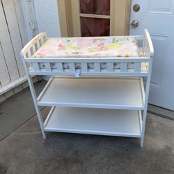 Baby changing table with two shelves below