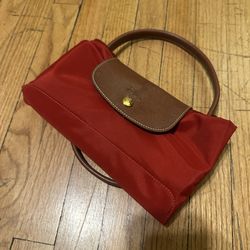 Longchamp Le Pliage nylon tote (red with brown leather flap and handles).