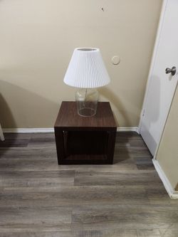 Nice nightstand with its lamp – in used condition