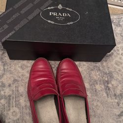 pair of red leather penny loafers from Prada